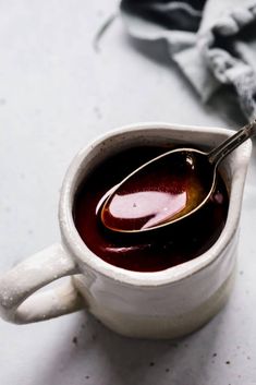 a spoon in a cup filled with liquid