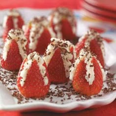 chocolate covered strawberries on a plate with white frosting and sprinkles