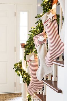 christmas stockings hanging from the banisters in front of a door