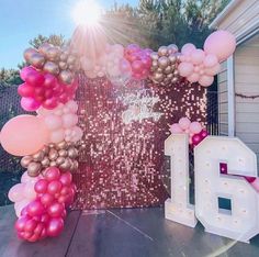 balloons and streamers are set up in front of the entrance to a home for an event