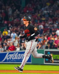 a baseball player running on the field during a game