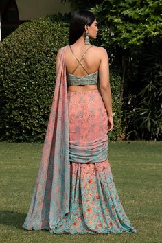 Peach and blue two tone saree with floral prints and hand embroidered waist brooch. Paired with a padded blouse with floral embroidery. - Aza Fashions Bohemian Fitted Pre-draped Georgette Saree, Fitted Sleeveless Georgette Blouse Piece, Fitted Sleeveless Blouse Piece In Georgette, Bohemian Fitted Silk Pre-draped Saree, Fitted Sleeveless Saree With Ruffles, Fitted Silk Sleeveless Sharara, Fitted Sleeveless Silk Pre-draped Saree, Fitted Sleeveless Georgette Choli, Fitted Sleeveless Georgette Pre-draped Saree