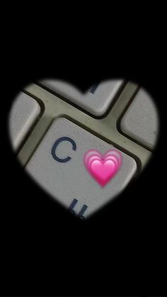 a keyboard with a pink heart on it's key and the letter c in the middle