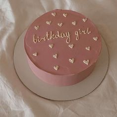 a pink birthday cake with hearts and the words birthday girl written on it in white frosting