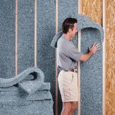 a man standing in front of a wall that is being built