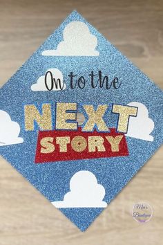 a blue graduation cap with the words on to the next story written in gold and red