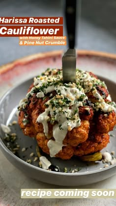 a plate with some food on it and a knife sticking out of the top one