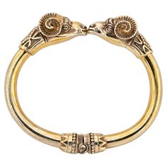 Past Marvels Revealed This outstanding antique Ram’s head bangle is a fine representation of the Etruscan revival made during 1880 ca It has been hand crafted of solid 18 KT gold with 50.00 grams weight Superb realistically done, like the real ones, two large Ram’s head meet face to face at the middle of the bangle, highly detailed in all aspects – granulation works and ancient geometries adorn the back heads and the hinged sides of the bangle, simply surprisingly beautiful throughout Etruscan j Ceremonial Yellow Gold Jewelry With Antique Finish, Antique Gold Bangle With Antique Finish, Ceremonial Antique Yellow Gold Cuff Bracelet, Antique Yellow Gold Cuff Bracelet For Ceremonial Occasions, Antique Gold Bangle Bracelet For Ceremonial Occasions, Antique Gold Bangle Bracelet For Ceremonies, Victorian Gold Bangle Bracelet For Ceremonial Occasions, Victorian Bangle With Intricate Design For Ceremonial Occasions, Antique Gold Cuff Bracelet With 17 Jewels