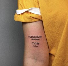 a woman with a tattoo on her arm that reads tomorrow, today and no one else