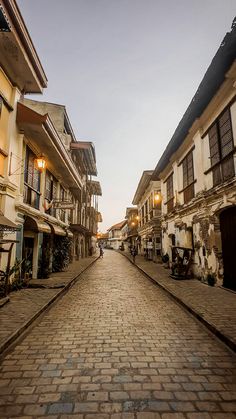 a cobblestone street lined with tall buildings