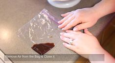 two hands reaching for a piece of chocolate on a counter top with the words remove air from the bag and close it