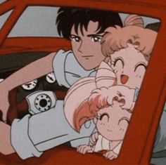 two people sitting in the back seat of a red car with anime characters on it