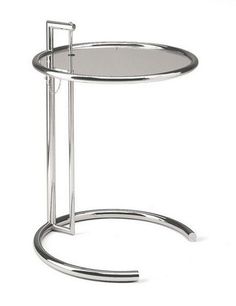 a round metal table with a glass shelf on the bottom and one section holding a magazine rack