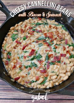 a skillet filled with beans, bacon and spinach