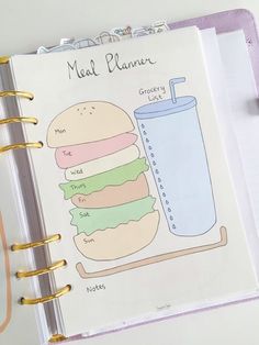 a planner with a hamburger and a drink on it