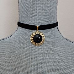 Black velvet ribbon is accented with a gold and black glass cabochon pendant focal. The pendant is linked on a gold slider pinch bail and the length of the choker is 13 " on first link closure.  Ribbon is fastened with gold metal crimps and there is an extension chain which makes for an adjustable fit up to 15" neck measurement with the gold hook closure. There is a wire wrapped gold flower bead dangle linked on the extension chain. All of my jewelry items come boxed, and ribbon tied and tagged. Elegant Black Choker With Black Ribbon, Formal Adjustable Black Ribbon Choker, Black Ribbon Necklace, Black Ribbon Choker Jewelry, Adjustable Black Ribbon Choker, Ribbon Choker Necklace, Black Velvet Ribbon, Ribbon Choker, Cabochon Pendant