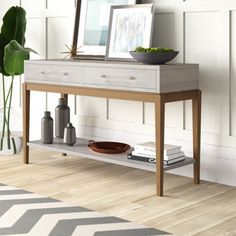 a wooden table with a white shelf on it and a plant in the corner next to it