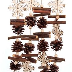 a group of pine cones and sticks with snowflakes hanging from the branches on them