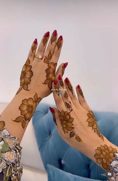 two hands with hendi designs on them