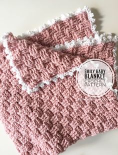 two pink crocheted baby blankets sitting next to each other