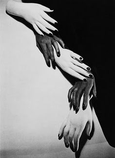 black and white photograph of four hands holding each other