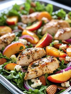 a salad with chicken, peaches and almonds