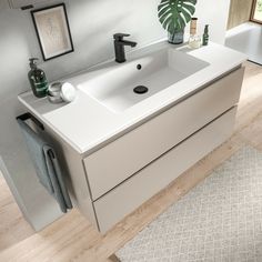 a bathroom sink sitting on top of a wooden floor