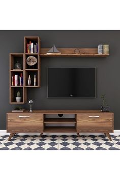 an entertainment center with bookshelves, shelves and a flat screen tv on the wall