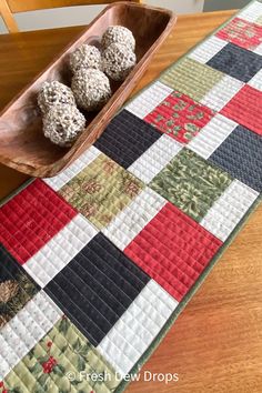 four chocolate truffles in a wooden bowl on a quilted table runner