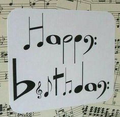 a birthday card with musical notes and the words happy birthday written in black on it