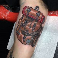 a tattoo on the arm of a man with a backpack