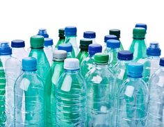 many plastic water bottles are lined up in a row and one is blue, the other is green