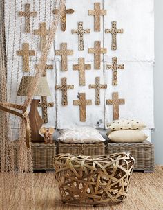 a wicker basket sitting next to a wall with crosses on it