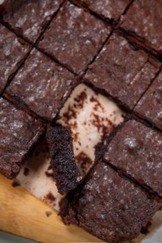 chocolate brownies cut into squares on top of a cutting board