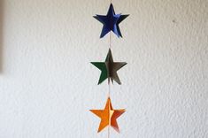 three paper stars hanging from a string