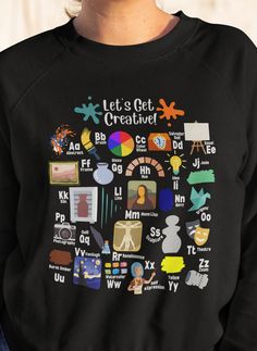 a woman wearing a black sweatshirt with the words let's get creative printed on it