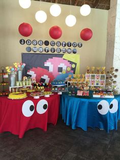 a table with two tables covered in red and blue cloths that have googly eyes on them