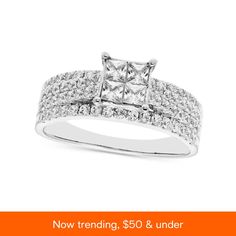 a white gold engagement ring with two rows of diamonds on the band and an orange background