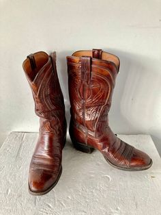 sz 8 D length:11"insole 10.5" width:4'' height: 12.5"calf width: 14 heel height:1.5'' LUCCHESE  BOOTS ARE TOP OF THE LINE BOOTS beautiful finely crafted LUCCHESE western boots vintage cognac brown premium leather cowboy boots fancy allover western art  top stitching  these boots can work for dress up or dress down leather lining and sole leather side pull ups good condition pull on low heel boots LUCCHESE label sustainable  made in TEXAS with pride Southwestern Style Boots With Round Toe For Western Events, Vintage Boots With Leather Sole And Square Toe, Southwestern Snip Toe Boots For Western-themed Events, Fitted Vintage Brown Western Boots, Fitted Vintage Boots With Goodyear Welt, Western Moto Boots With Almond Toe, Fitted Vintage Boots With Goodyear Welted, Southwestern Fitted Boots With Round Toe, Fitted Brown Moto Boots For Western-themed Events