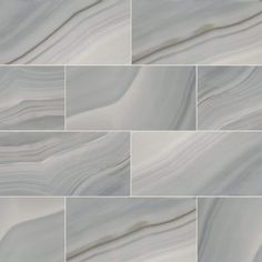 white marble tiles with wavy lines on the bottom, and grey veining in the middle