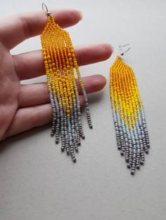 Long fringe beaded earrings in bright luxury color combination: light orange, yellow, light grey and grey. Earrings are made of quality Czech beads and strong thread. You can choose the option of a metal hook or 925 sterling silver. Length without hook 10 cm / 4 inches Length with hook 11,5 cm / 4.33 inches Width 2 cm / 0.8 inches You can see the whole process of creating my jewelry on my Facebook page, just subscribe to it at the link: https://www.facebook.com/babusynipatsiorky/ Don't forget to Fringe Bead Earrings, Sea Earrings, Blue Beaded Earrings, Long Chandelier, Grey Beads, Cadeau Photo, Earrings Bohemian, Seed Bead Earrings, Etsy Earrings Dangle