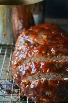 meatloaf with sauce on top sitting on a grill