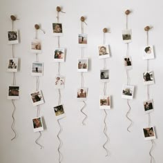 several pictures hanging on a wall with string attached to them and photos pinned to the wall