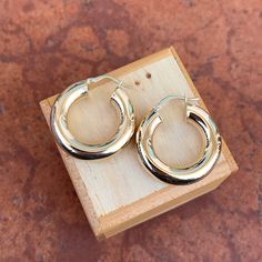 10KT yellow gold shiny-finish, chunky tube, round hoop earrings. Beautiful, thick, and medium size hoops. Length: 27mm Width: 26mm Thickness: 6mm Weight: 4.03 grams Stamped 10K Latch back closure Hollow tubes Phone Ring, Medium Size, Hoop Earrings, Yellow Gold, Yellow, Electronic Products, Gold