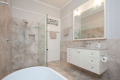 a bathroom with a tub, sink and shower in it's own area is shown