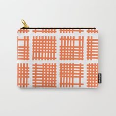 an orange and white checkered pattern with gold zippered closures on a zipped pouch