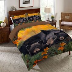 two bears in the woods with autumn leaves and pine cones printed on this bedding set