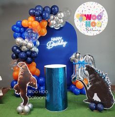 an assortment of balloons and decorations for a dinosaur themed birthday party at woo hoo balloons