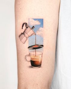 a person with a tattoo on their arm that has coffee being poured into a cup