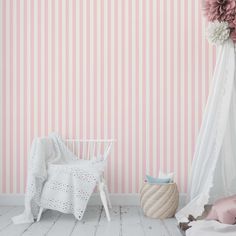 a pink and white striped wallpaper in a child's room